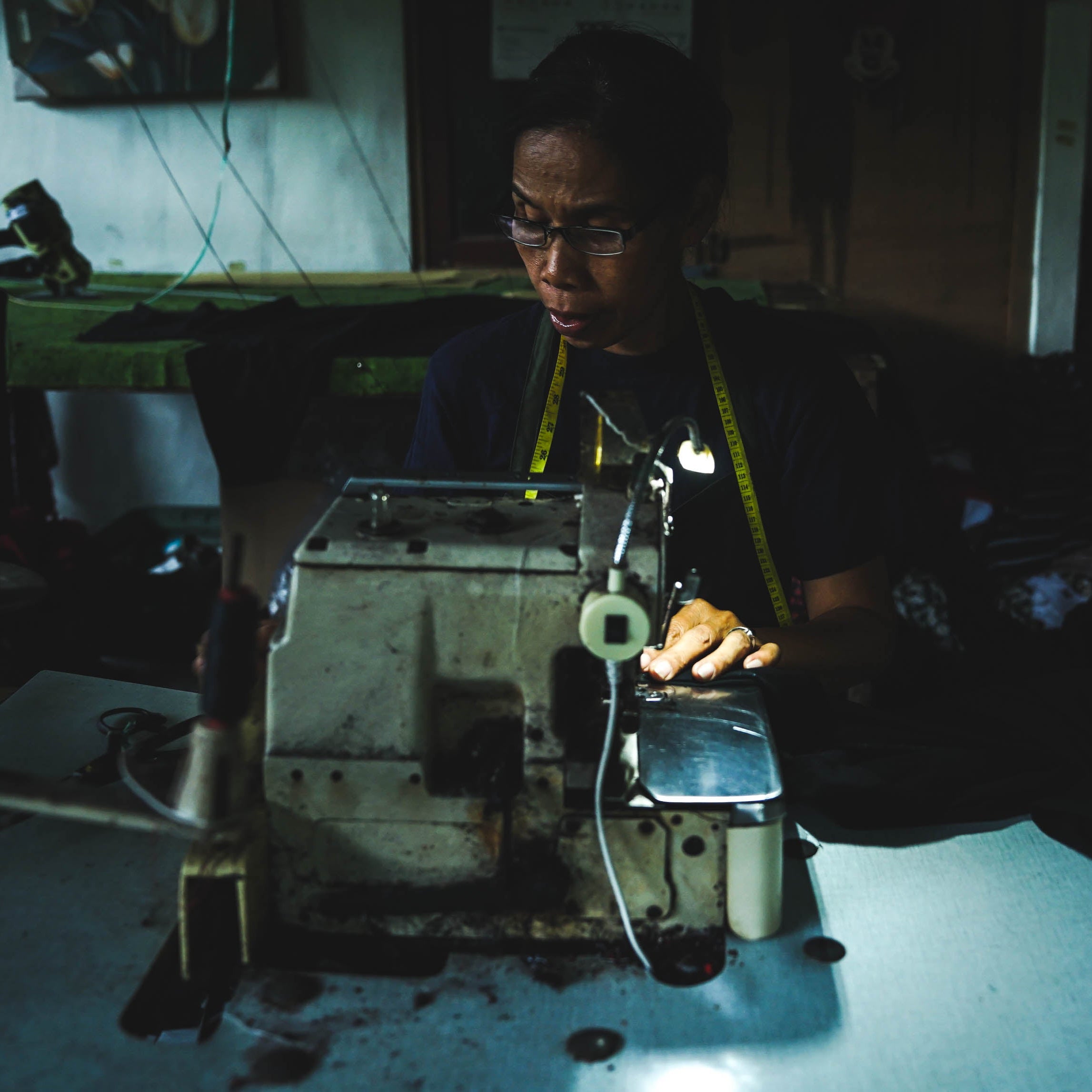 Person working on a sewing machine.