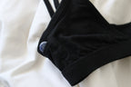 A focused shot of an Alma bralette with a Sodalite pocket crystal peeking out of a subtle side pocket of the bralette.
