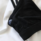 A focused shot of an Alma bralette with a Sodalite pocket crystal peeking out of a subtle side pocket of the bralette.